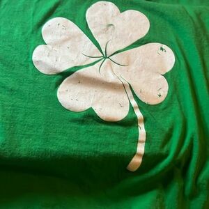 Green shirt with white four leaf clover on front